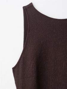 Detail of dark coffee sleeveless dress featuring unique textured bubble fabric and round neck