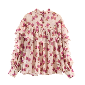 Close-up of floral chiffon shirt showing layered ruffles and rose pattern detail