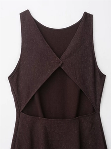 Detailed view of dark brown textured fabric with open back design and invisible zipper