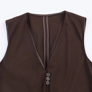 Close-up of deep V-neckline on brown vest with three buttons and neat inner seams