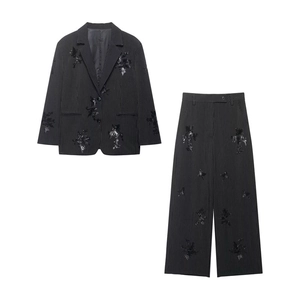 Close-up of black pinstripe suit with floral embroidery and sequins detailing