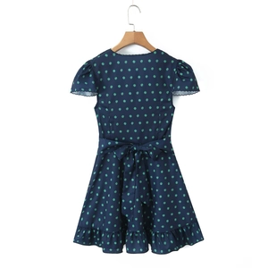 Detail of scalloped sleeve cuffs and waist bow tie on a navy blue floral summer dress