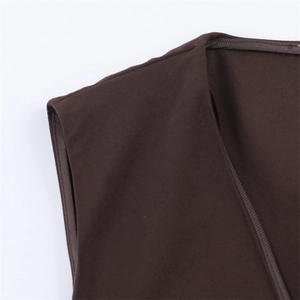 Detail shot of brown asymmetrical top showing high-quality stitching and fabric texture