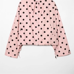 Pink and black polka dot lightweight short jacket with drawstring hem and buttons