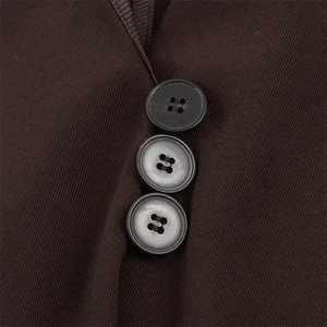 Macro shot of dark brown fabric texture and three circular buttons on an asymmetric top
