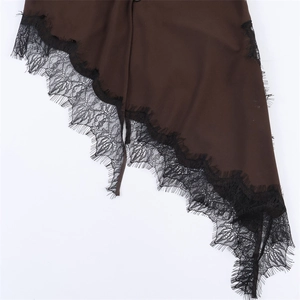 Detail of dark brown fabric with delicate black eyelash lace trimming on the edge