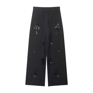 Detail of high waisted pinstripe wide leg trousers with black sequin bee embroidery