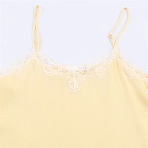 Close-up of light yellow camisole top with delicate floral lace trim and adjustable straps