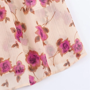 Detail of rose print chiffon fabric showing light texture and semi-sheer finish