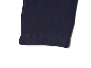 Détail du poignet d'un sweat-shirt bleu marine montrant des coutures à double aiguille