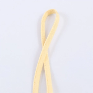 Detailed view of the yellow lacy top's adjustable straps and precise stitching details