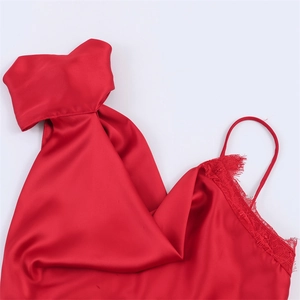Detail of red satin top featuring delicate lace trim and elegant halter neckline