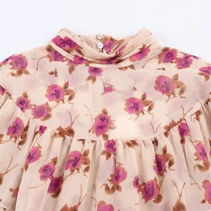 Women's floral chiffon blouse featuring a mock neck and elegant rose print details