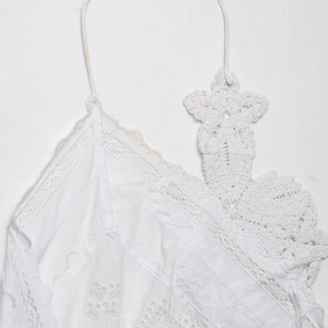 White crochet lace camisole top with intricate floral embroidery and scalloped edges