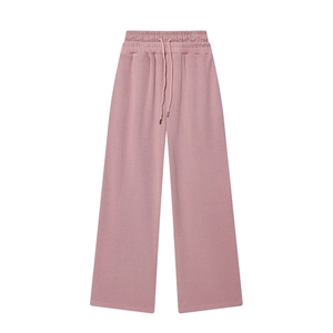 Detail of high-waist elastic waistband with drawstring on pink wide-leg trousers
