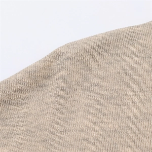 Macro shot of vertical knit texture on beige high neck dress fabric