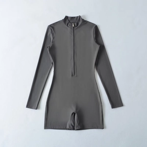 Detail view of dark grey long sleeve athletic bodysuit with front zipper and stand collar