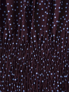 Macro shot of brown polka dot fabric with elastic smocking detail for women shirt