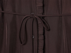 Detailed close-up of dark brown dress featuring ruffled placket and slim drawstring tie