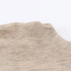 Macro shot of light beige ribbed knit fabric texture on long sleeve dress