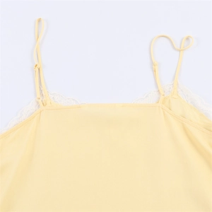 Elegant light yellow camisole top with white lace trim and adjustable shoulder straps