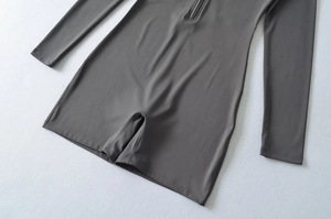 Detailed flat lay of a grey slim fit long sleeve bodysuit with front zipper closure