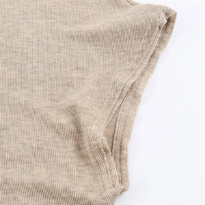 Close-up of the light coffee ribbed knit fabric showing fine stitching and texture detail