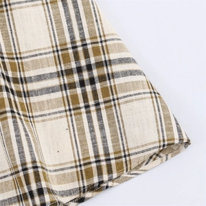 Detail of olive green and black plaid pattern on asymmetrical high-quality skirt fabric