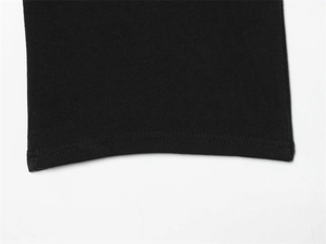 Detail shot of the black knit fabric sleeve cuff with neat double-needle stitching finish