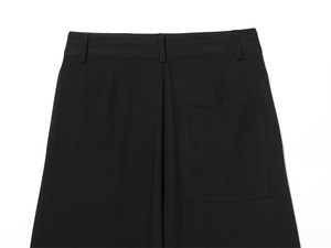 Detailed view of the back waistband and square patch pocket on black casual trousers