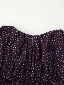 Close-up of pleated neckline with teardrop opening on dark brown polka dot blouse