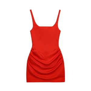 Close-up of ruched side details and structured corset bodice on red mini dress