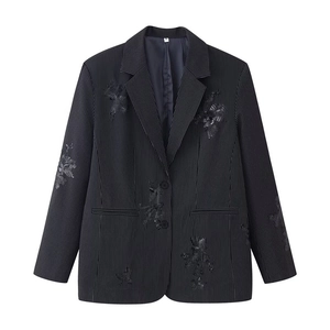 Detail of slim fit black striped blazer featuring elegant sequin floral embroidery