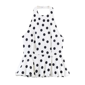 Detailed flat lay of a white polka dot peplum top with a stylish halter neckline