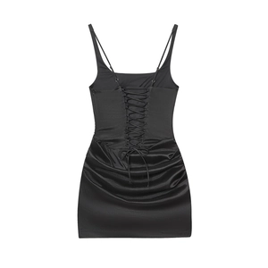 Detail of black satin bodycon dress featuring criss-cross lace-up back and ruching