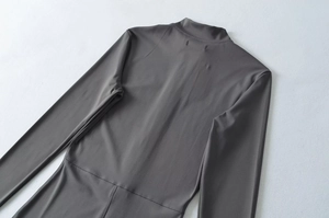 Detail view of charcoal gray slim fit bodysuit showing back stitching and ribbed texture