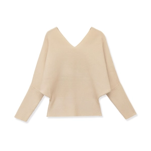 Detail of beige V-neck knitted sweater featuring batwing sleeves and fine flat knit texture