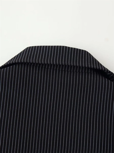 Detailed close-up of notched lapel on black and white striped formal blazer suit jacket