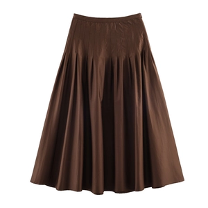 Detailed view of deep brown pleated A-line midi skirt with subtle glossy woven fabric