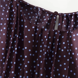 Elegant dark purple polka dot shirt featuring a pleated neckline and blue dots pattern