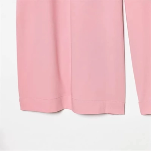 Pink wide-leg trousers with central pressed crease and premium tailored cuff detail