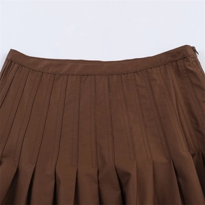 Detailed close-up of dark brown high waist pleated skirt with side invisible zipper