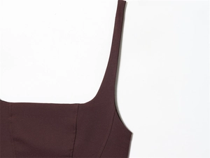 Detailed macro shot of the square neckline and fine stitching on a dark red sleeveless dress