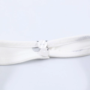 Detail view of white fabric featuring two round flat buttons and fine double-needle stitching