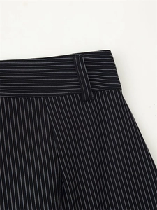 Detailed view of high-quality striped suit trousers featuring precise waist stitching