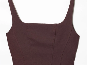 Detailed view of the square neckline and vertical seams on the burgundy sleeveless top