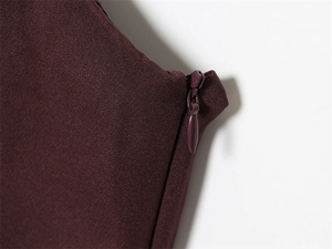 Detail of invisible back zipper and fine woven fabric texture on burgundy dress