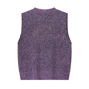 Detailed view of purple knit vest featuring shimmering silver sequins and plush texture