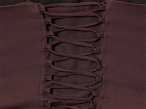 Detail shot of the criss-cross lace-up design on the back of the wine red bodycon dress