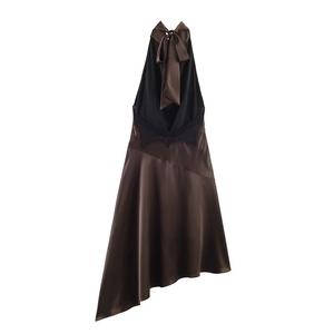 Detail of satin dress with halter bow neckline, black lace trim and asymmetrical hem